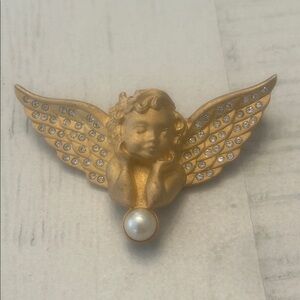 This is a vintage Swarovski gold-tone angel brooch pin